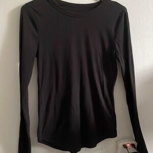 Plain black shirt. Brand new- could use an iron.